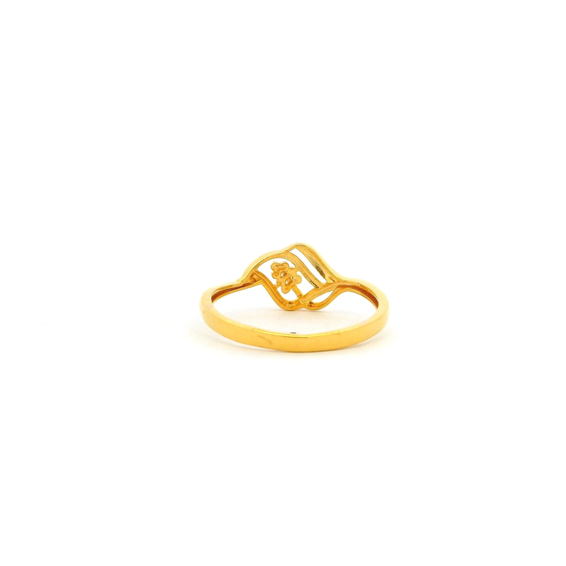 Gold ring with a small design on a white background