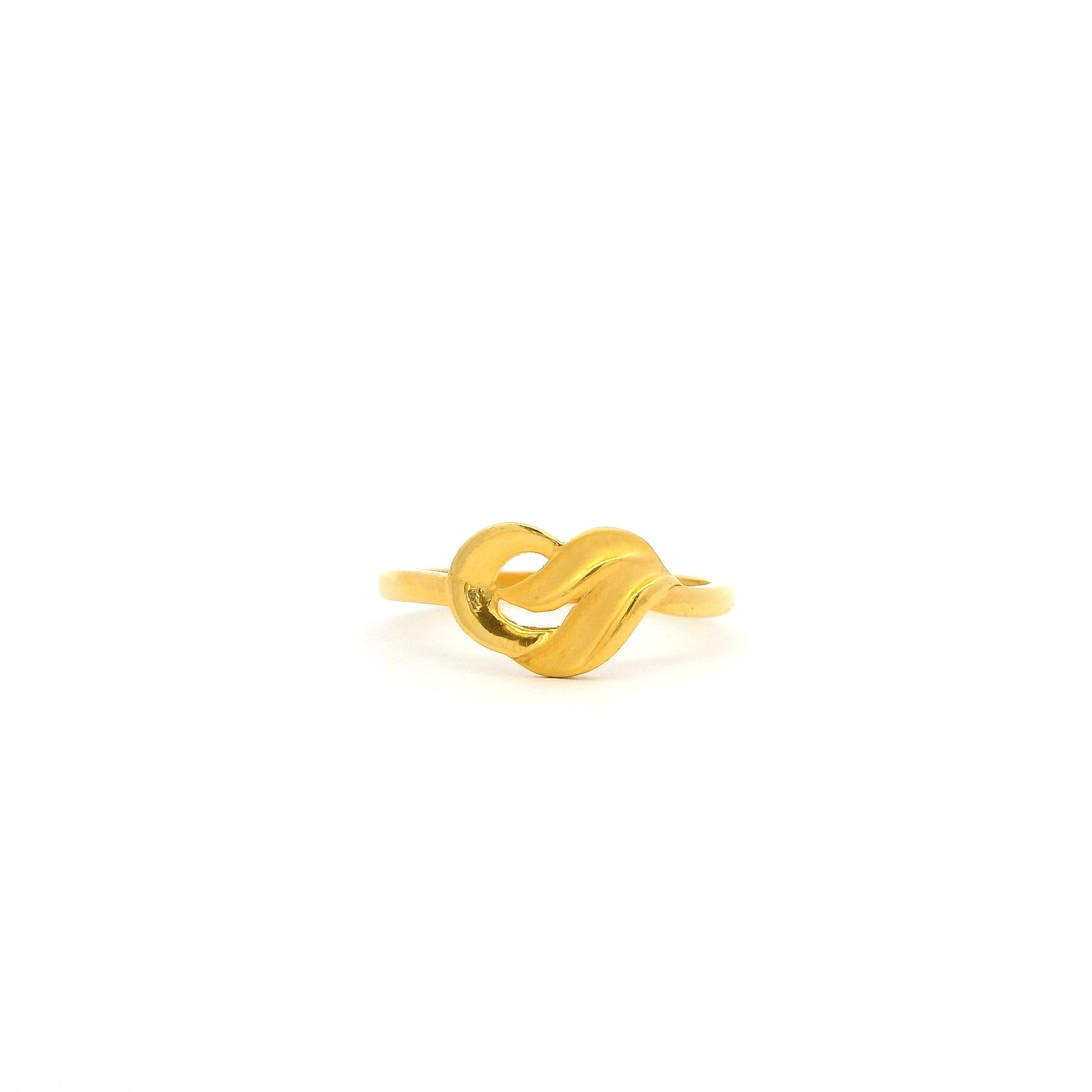 Gold ring with a knot design on a white background