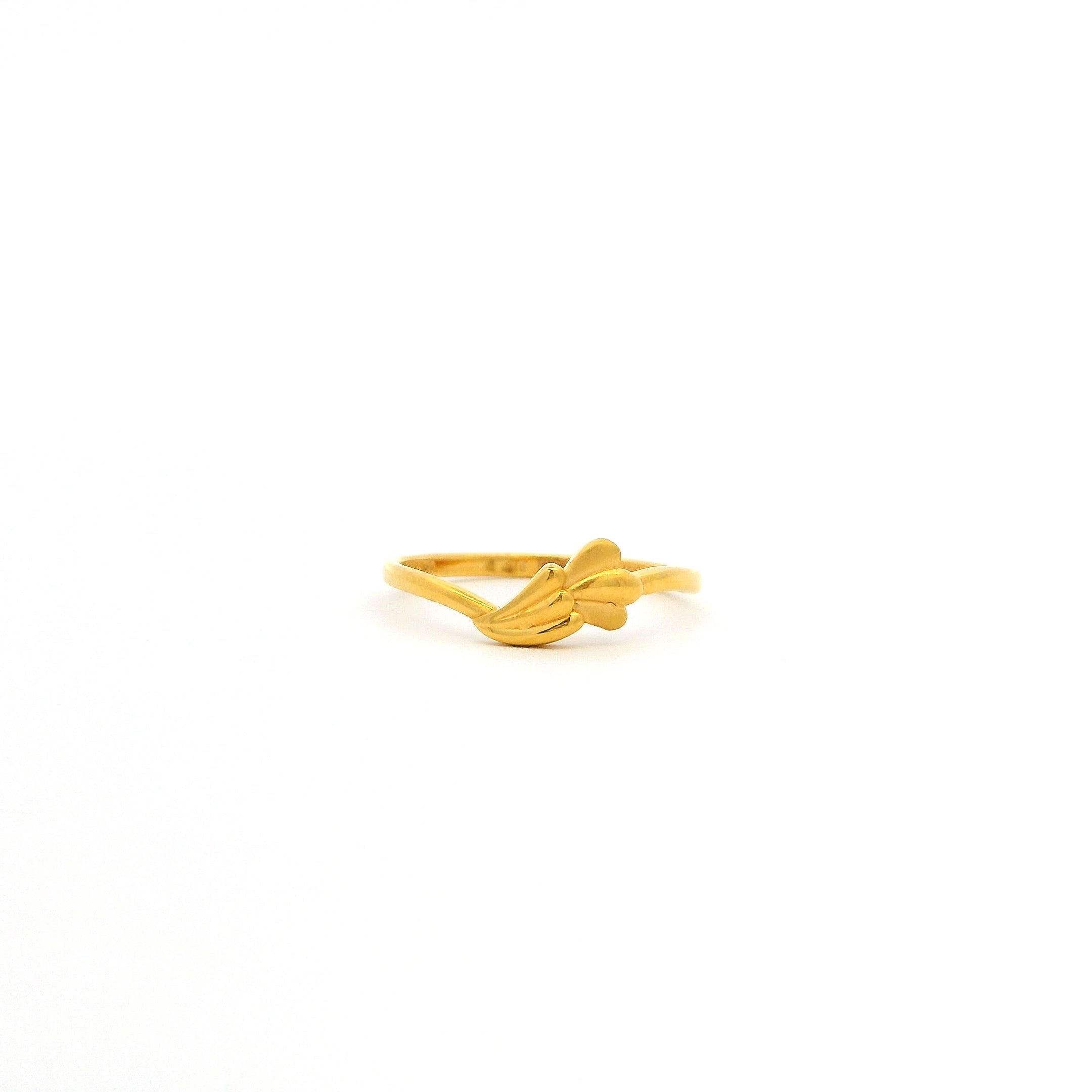 Gold ring with a leaf design on a white background