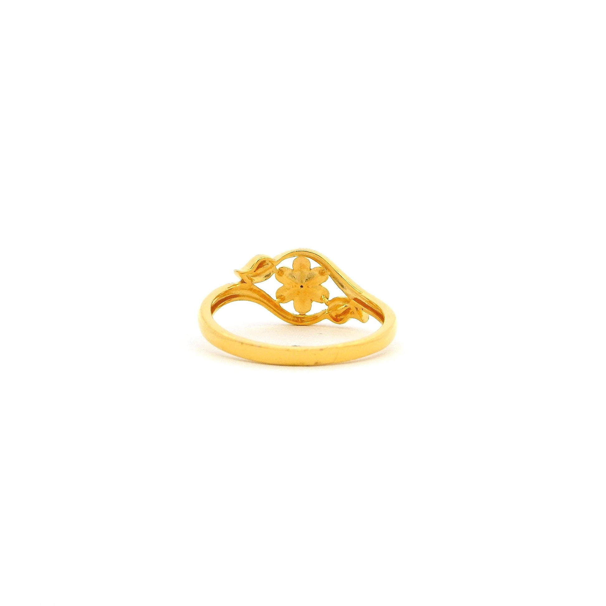 Gold ring with a floral design on a white background